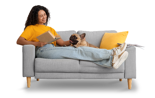 Woman relaxes on loveseat with her pug or bulldog type dog