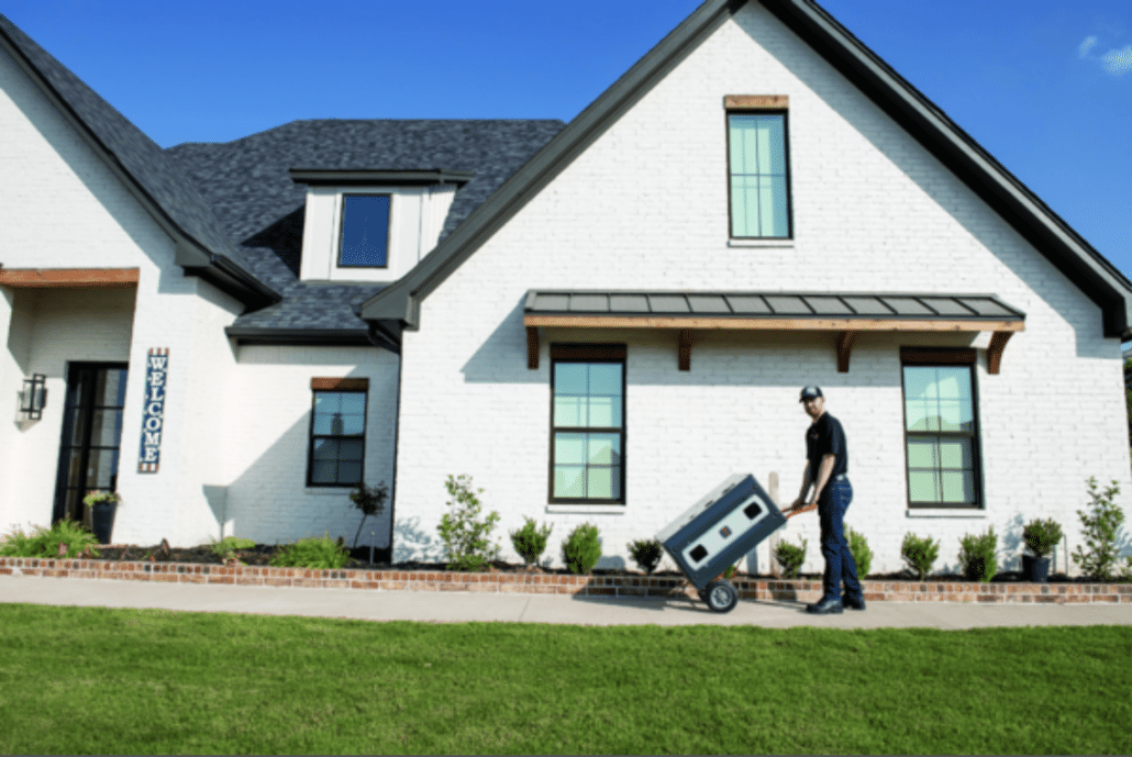 HVAC technician delivering a whole-home generator to a residential property
