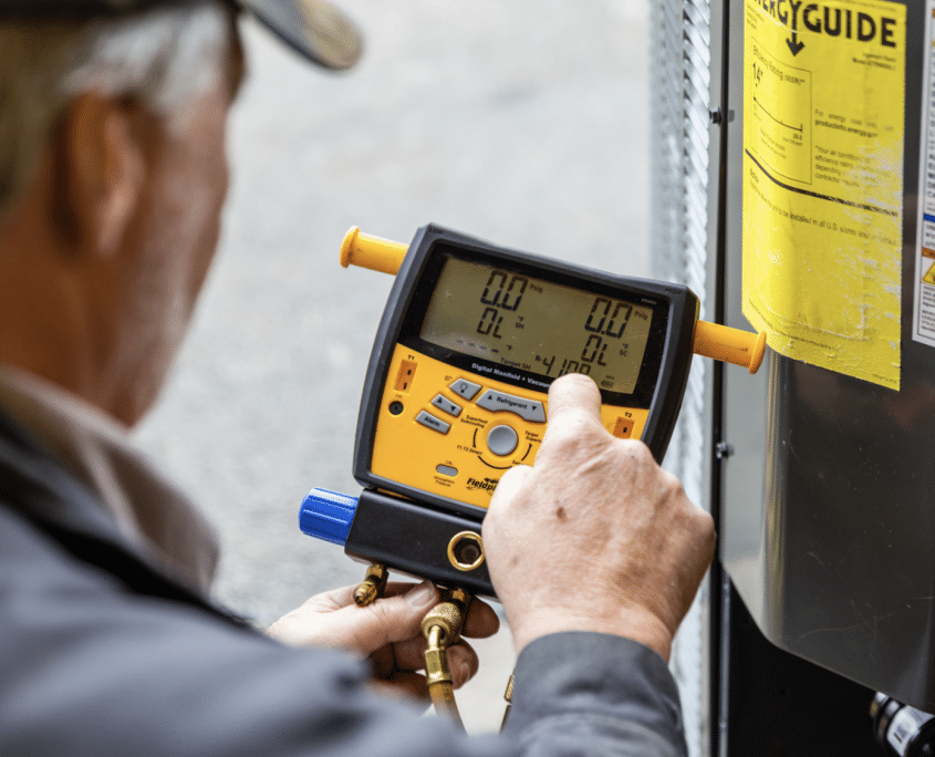HVAC technician performing AC system diagnostics and refrigerant testing