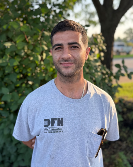 Portrait of a DFH technician in front of a tree